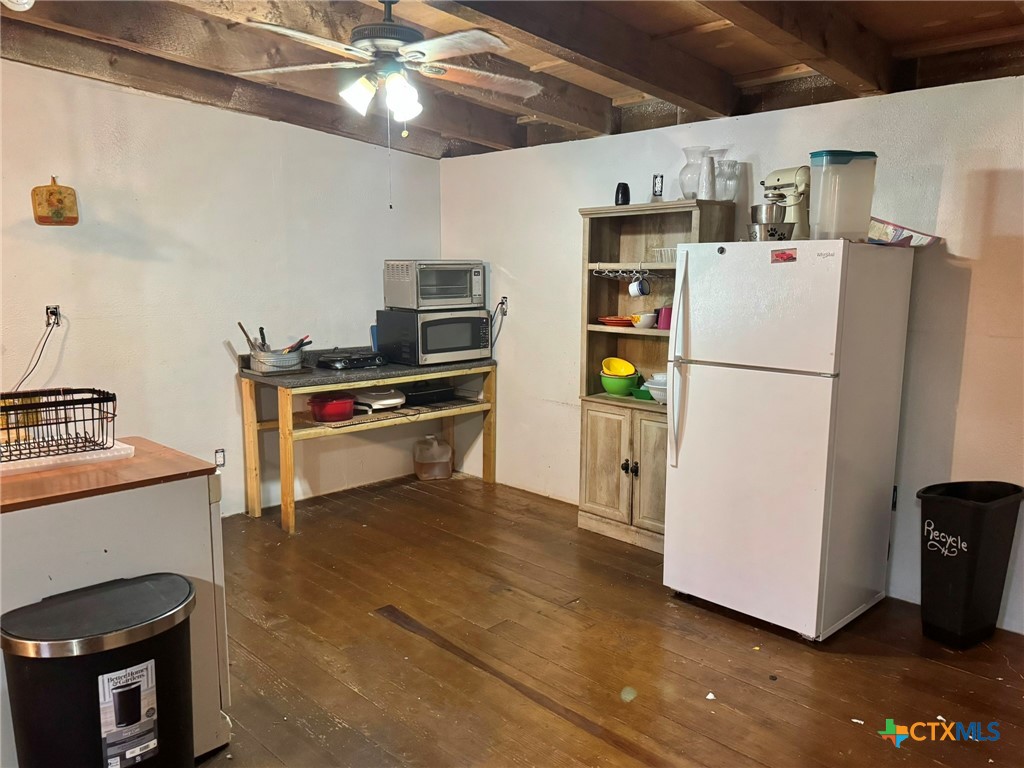 3221 West Ave R Temple, TX 76504 - Photo 45 of 48 a white refrigerator freezer and a stove sitting inside of a kitchen