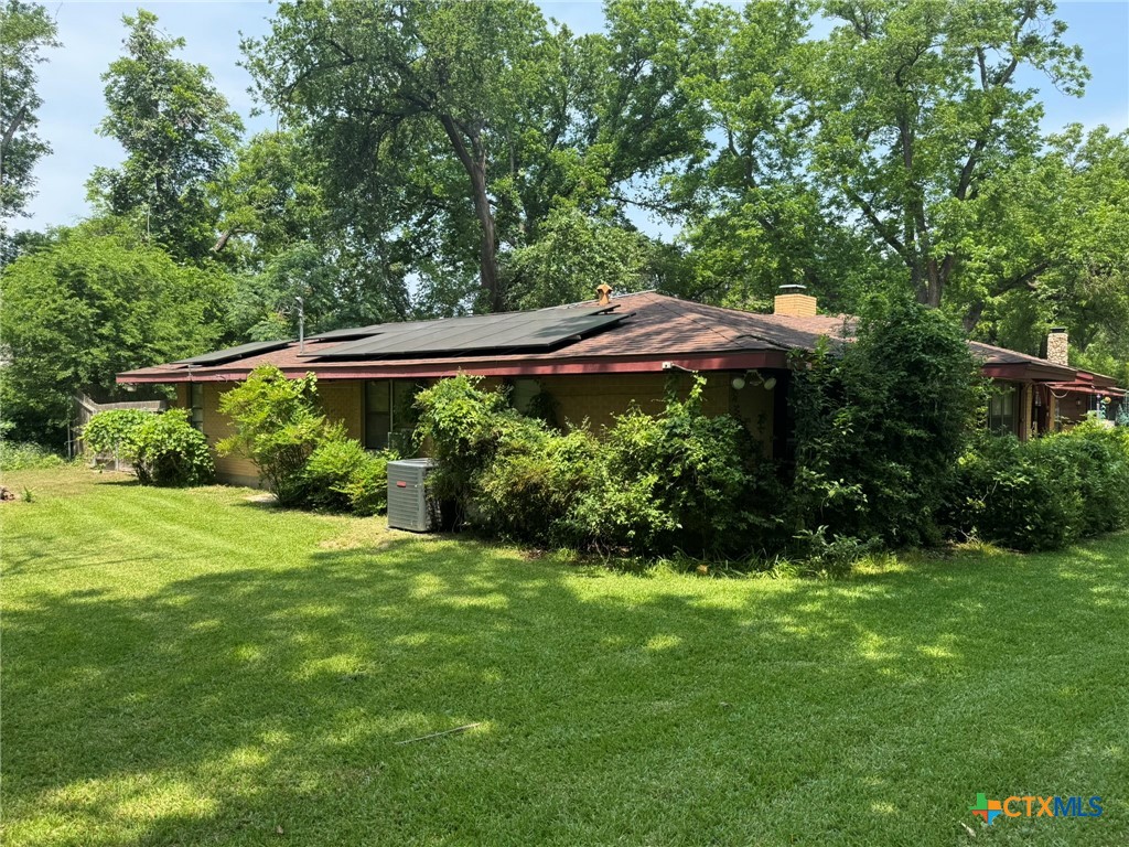 3221 West Ave R Temple, TX 76504 - Photo 8 of 48 a view of a backyard with plants and a garden