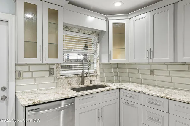 a kitchen with a sink and cabinets