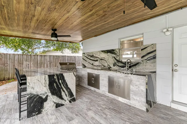 a view of a porch floor to ceiling window and wooden floor