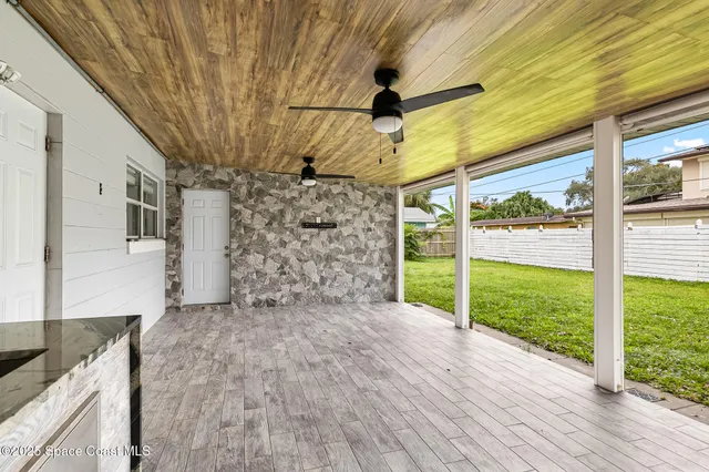a kitchen with a stove and a wooden wall