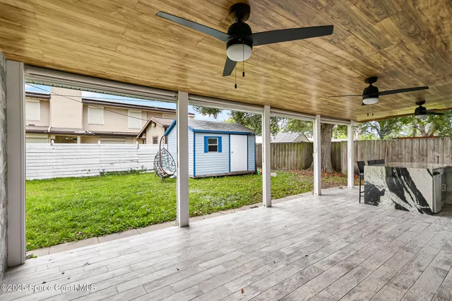 a view of small house with backyard