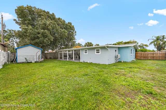 a view of a backyard with sitting area