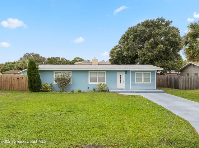 a view of a house with a yard and a garden