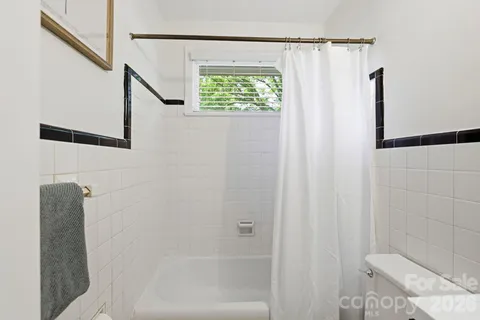 a bathroom with a shower and a toilet