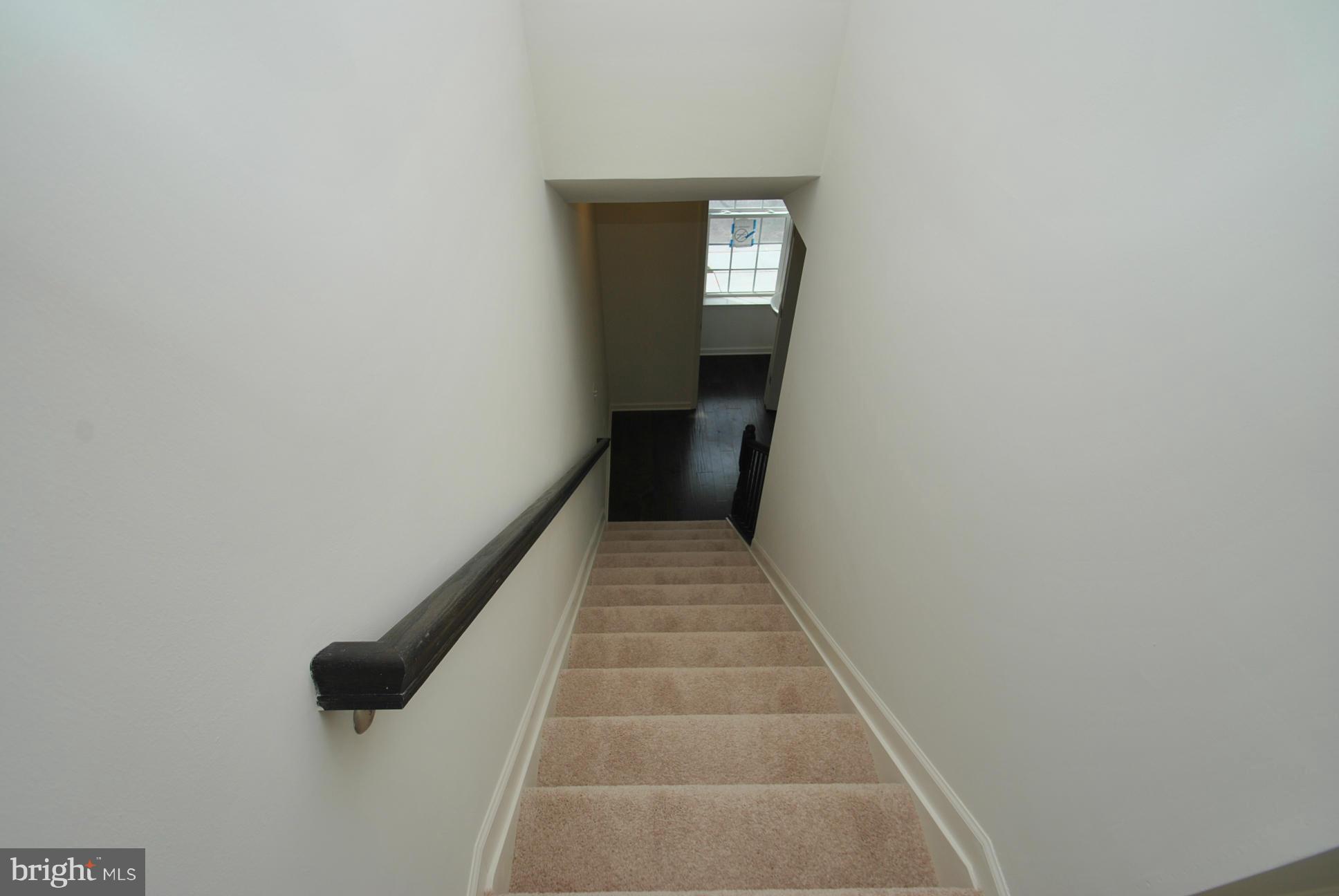 10416 Braddock Run Road Middle River, MD 21220 - Photo 5 of 20 a view of a hallway with wooden floor and a white wall