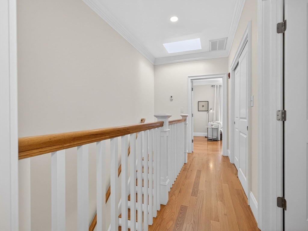 213 Lamartine Street, Unit 213A Boston, MA 02130 - Photo 16 of 39 a view of a hallway with wooden floor and staircase