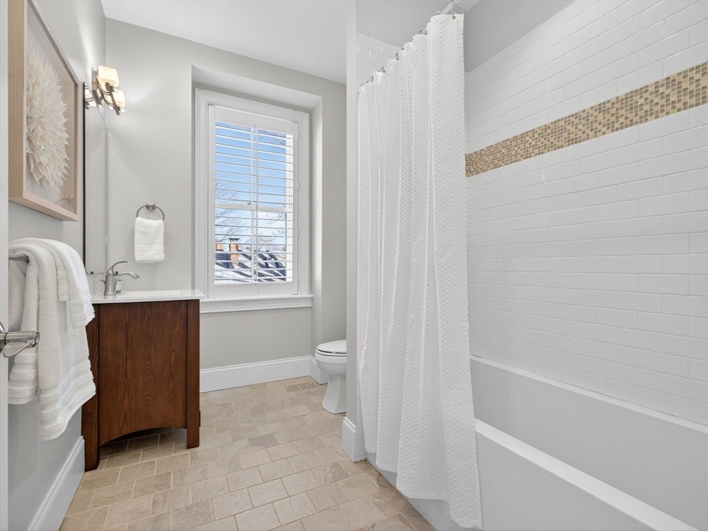 213 Lamartine Street, Unit 213A Boston, MA 02130 - Photo 26 of 39 a bathroom with a sink a toilet and a bathtub