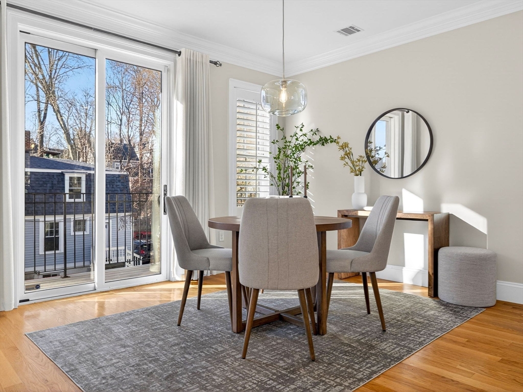 213 Lamartine Street, Unit 213A Boston, MA 02130 - Photo 7 of 39 a dining room with furniture a window and wooden floor