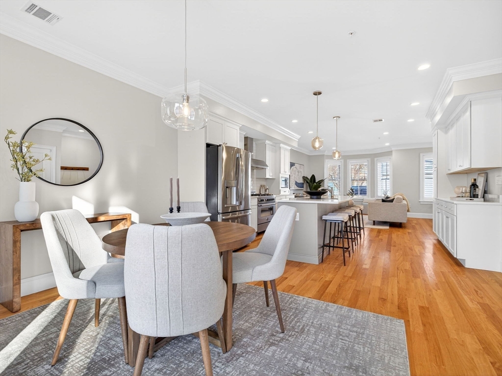 213 Lamartine Street, Unit 213A Boston, MA 02130 - Photo 8 of 39 a dining room with furniture a chandelier and wooden floor