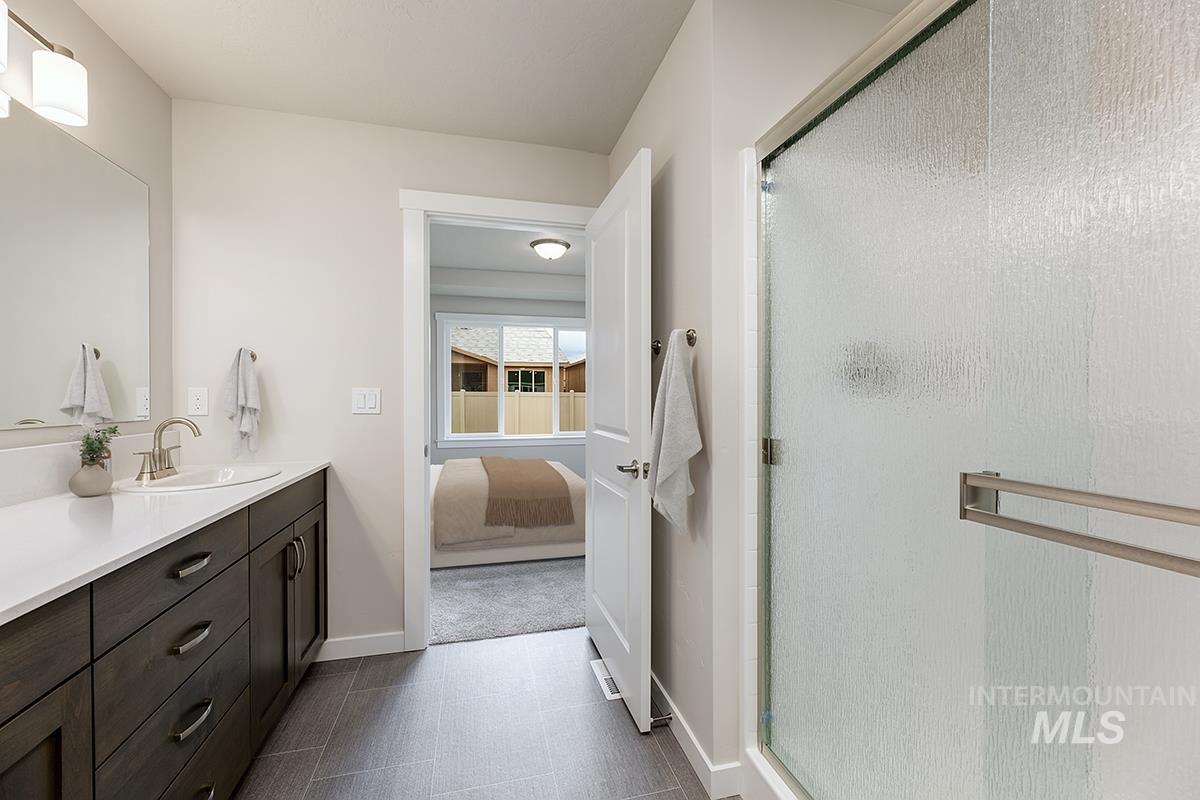 7080 South Gamely Avenue Meridian, ID 83642 - Photo 12 of 30 Bathroom featuring vanity, a shower stall, and connected bathroom