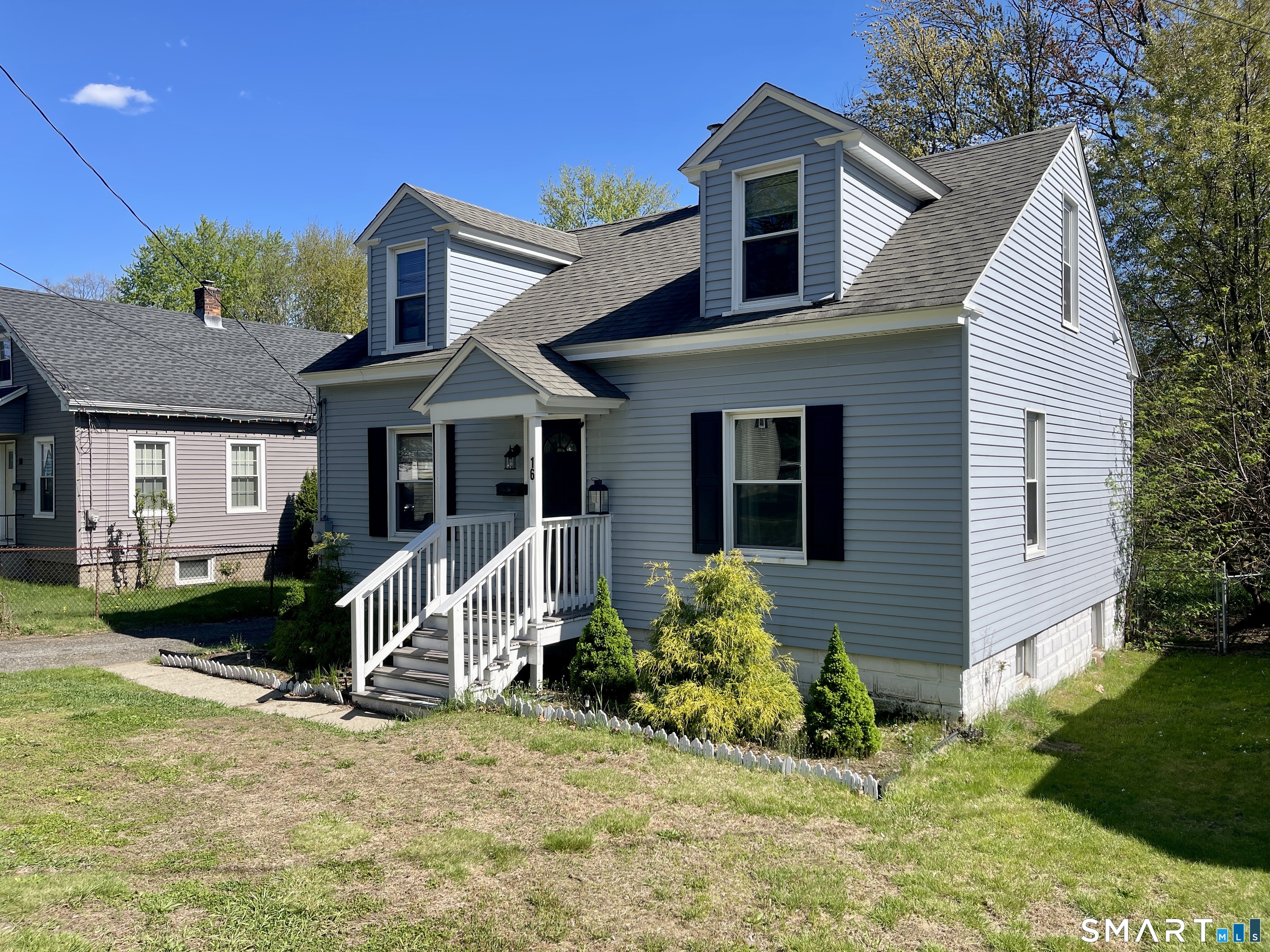 16 Brainard Road Enfield, CT 06082 - Photo 1 of 32 a view of a house with a yard and lawn chairs with a fire pit