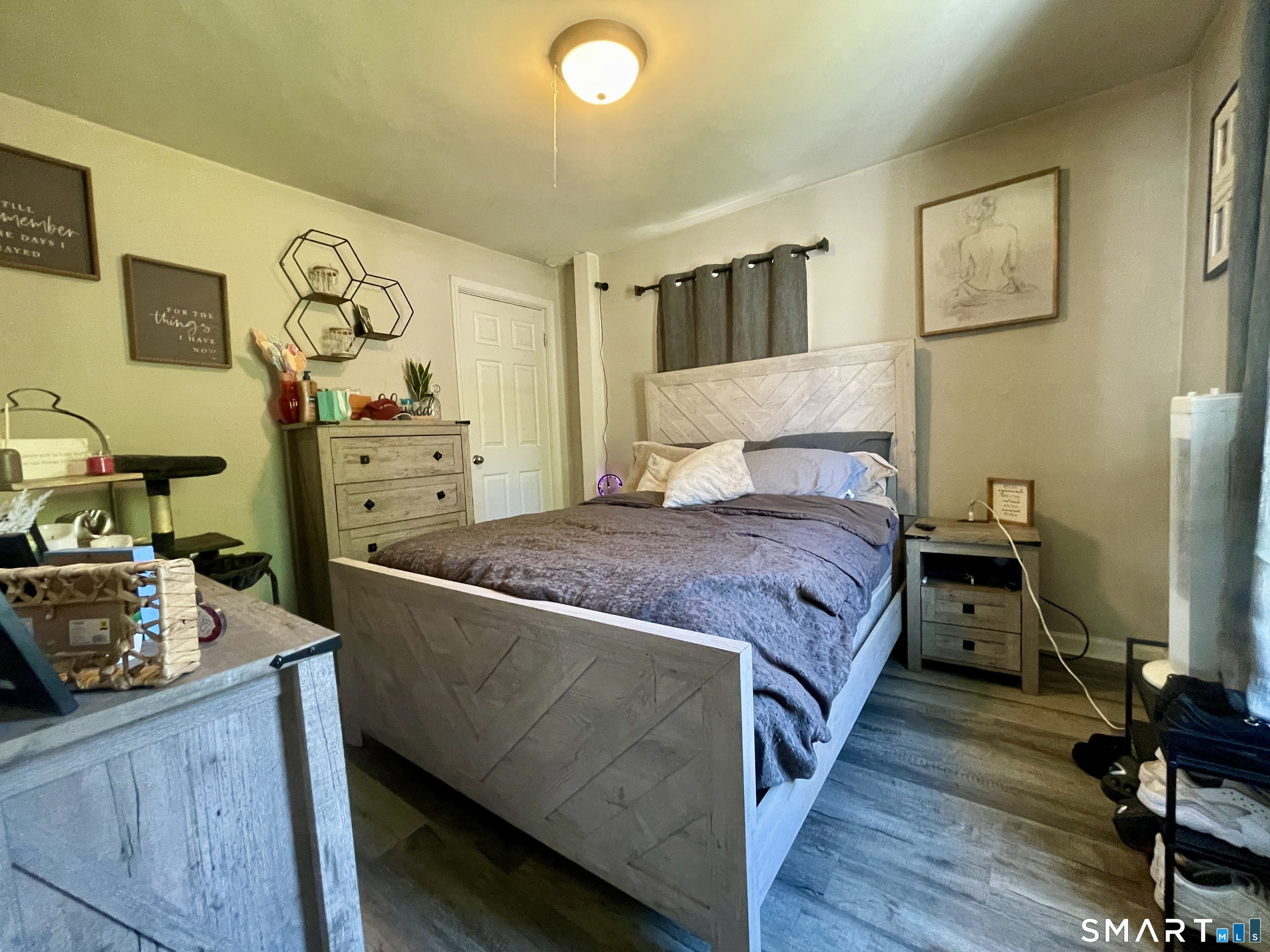 16 Brainard Road Enfield, CT 06082 - Photo 19 of 32 a bedroom with a bed and wooden floor