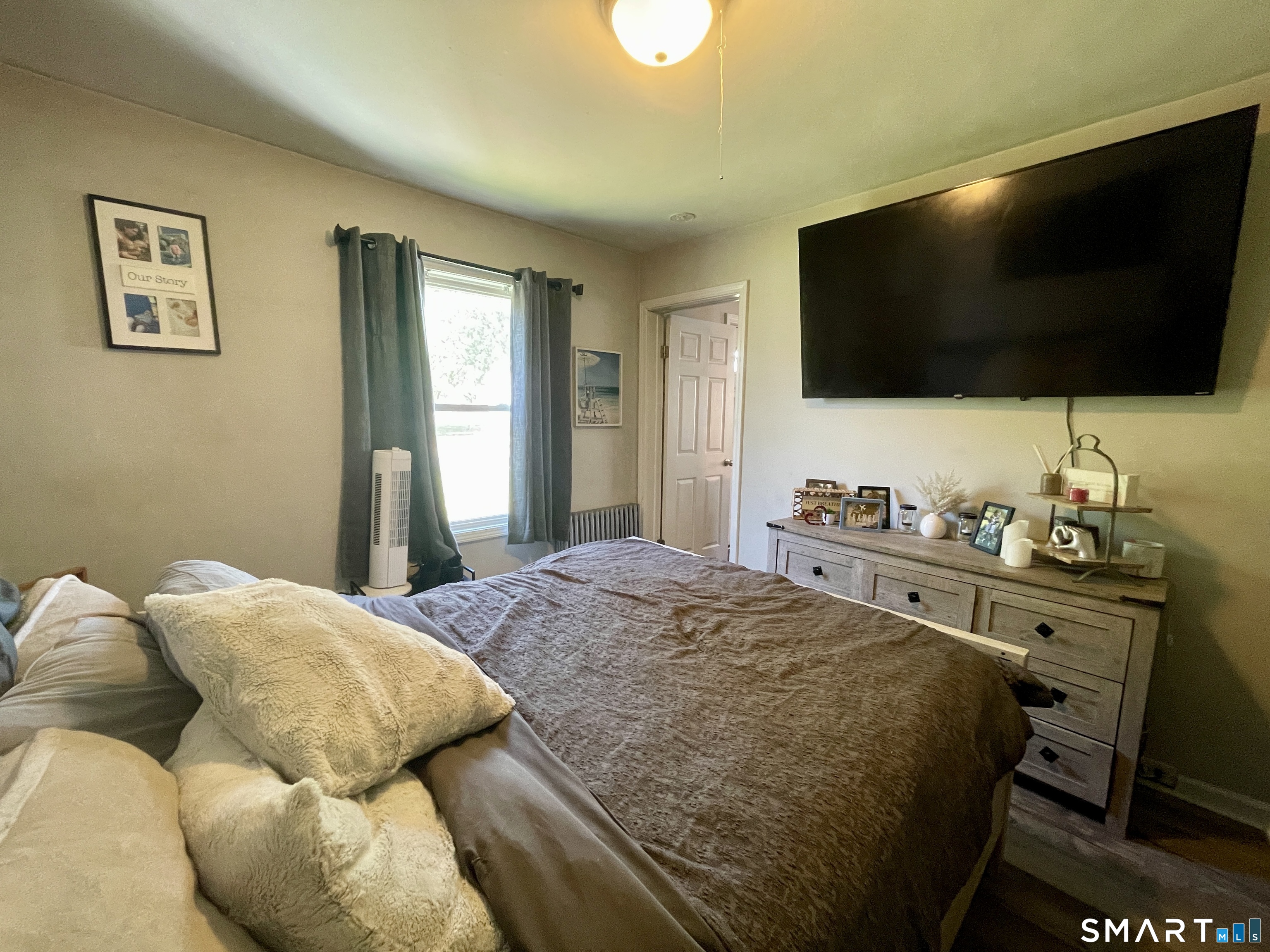 16 Brainard Road Enfield, CT 06082 - Photo 20 of 32 a bedroom with a bed and a flat screen tv
