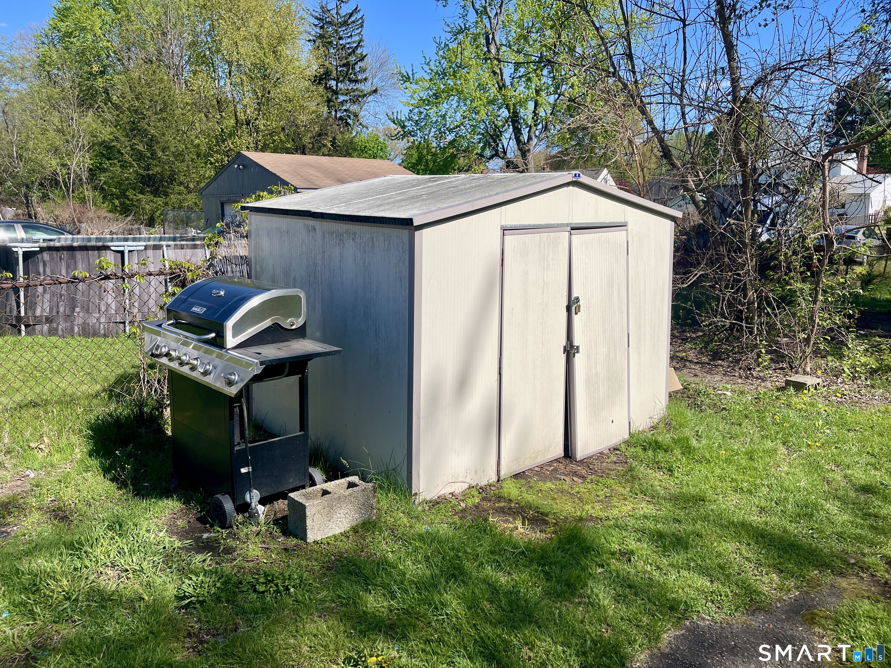 16 Brainard Road Enfield, CT 06082 - Photo 30 of 32 a backyard of a house with table and chairs