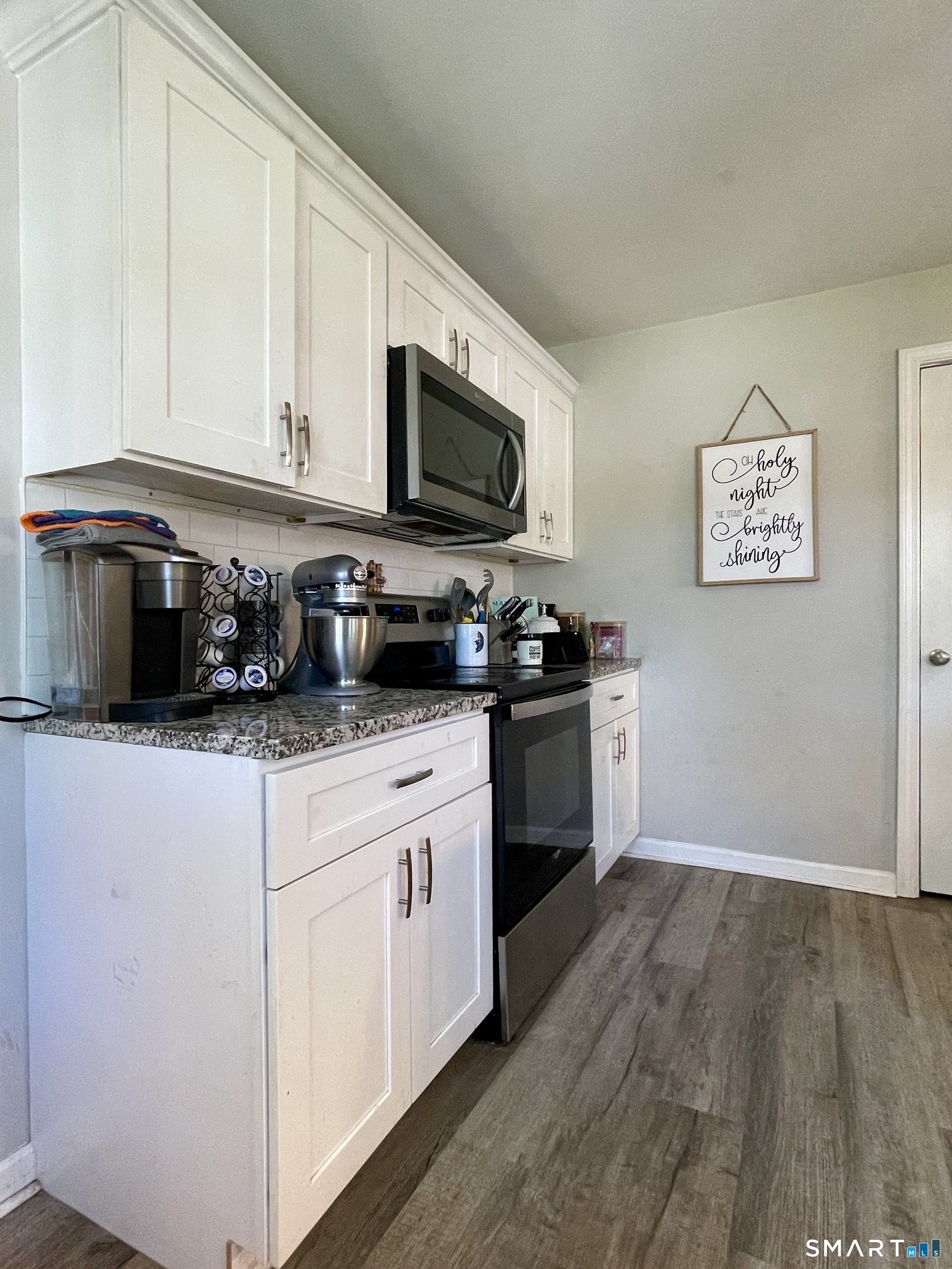 16 Brainard Road Enfield, CT 06082 - Photo 7 of 32 a kitchen with stainless steel appliances granite countertop a stove a sink and a microwave