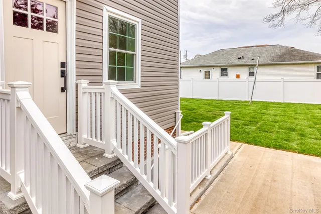 a view of a house with backyard and deck