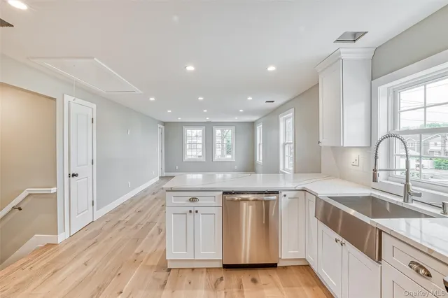 a kitchen with granite countertop white cabinets and white appliances
