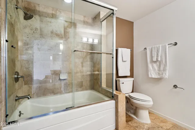 a hallway with wooden floor and large window