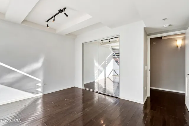 a room with wooden floor and outdoor view