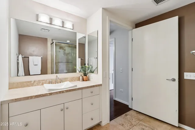 a kitchen with stainless steel appliances a stove a refrigerator and cabinets