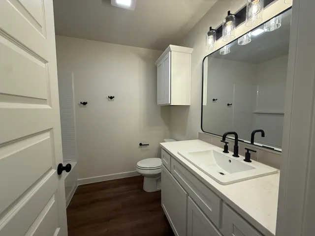 a bathroom with a sink toilet and shower
