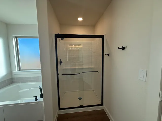 a bathroom with a glass shower door