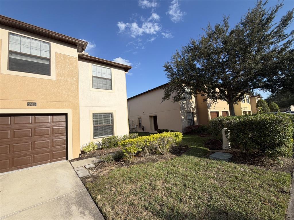 a backyard of a house with table and chairs