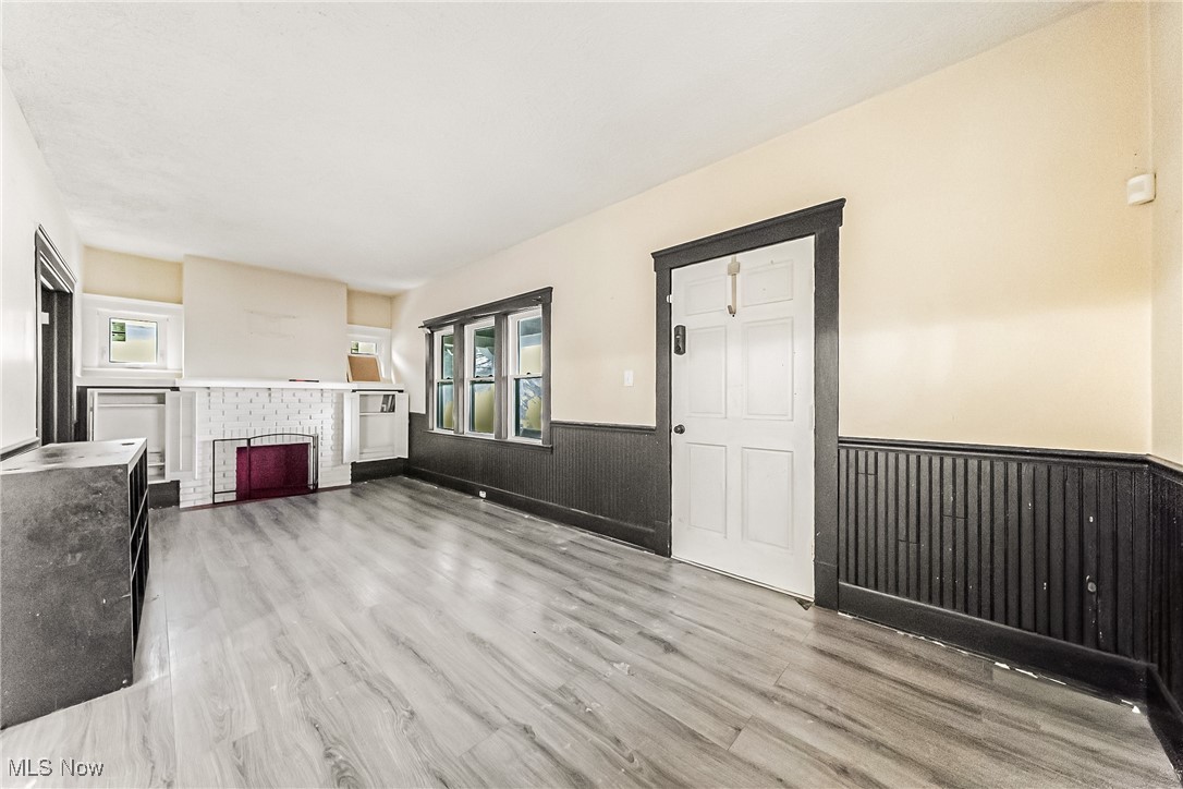 2014 Cook Avenue Cleveland, OH 44109 - Photo 4 of 37 Unfurnished living room featuring light hardwood / wood-style floors and a brick fireplace