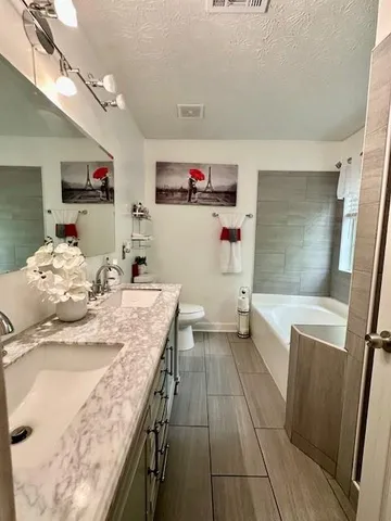 a room with a washing machine and wooden floor
