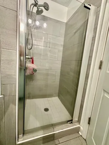 a bathroom with a glass shower door