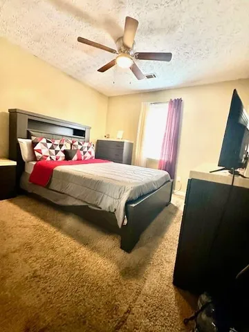 a bedroom with a bed and window