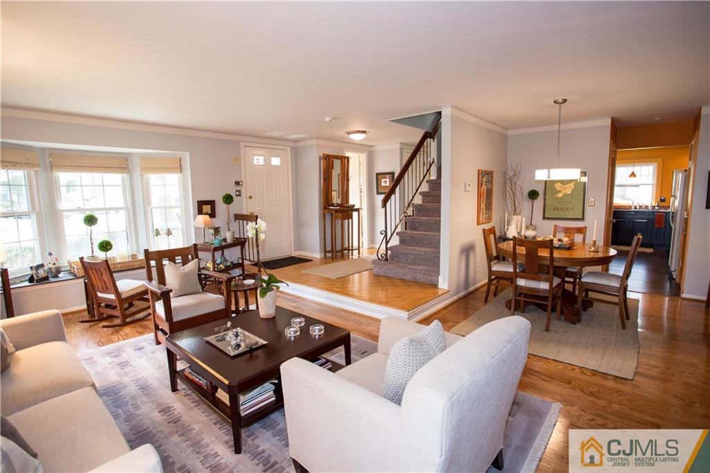 1301 Timber Oaks Road, Unit 1301 Edison, NJ 08820 - Photo 2 of 25 a living room with furniture a rug kitchen view and a large window