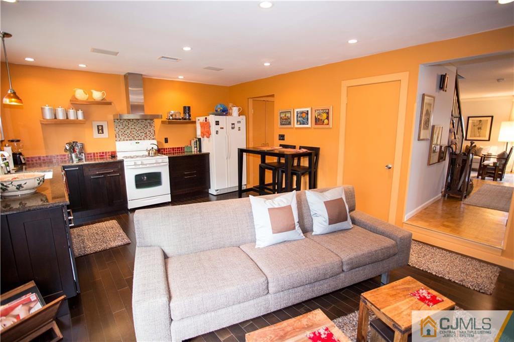 1301 Timber Oaks Road, Unit 1301 Edison, NJ 08820 - Photo 11 of 25 a living room with furniture kitchen area and a wooden floor