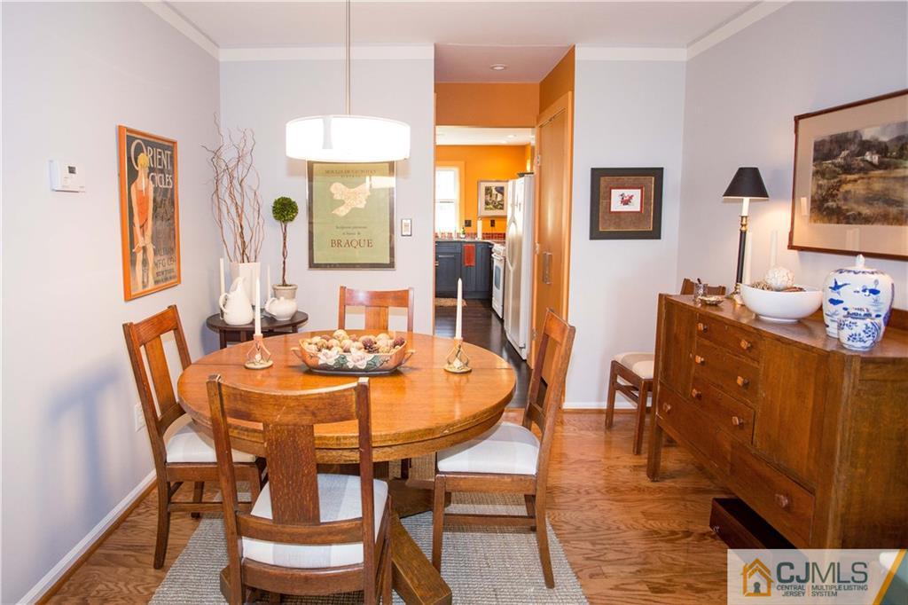 1301 Timber Oaks Road, Unit 1301 Edison, NJ 08820 - Photo 14 of 25 a dining room with furniture a window and a chandelier