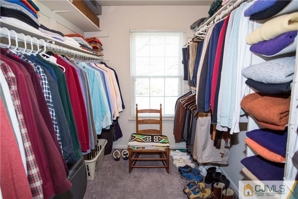1301 Timber Oaks Road, Unit 1301 Edison, NJ 08820 - Photo 20 of 25 a view of walk in closet with clothes and shoes