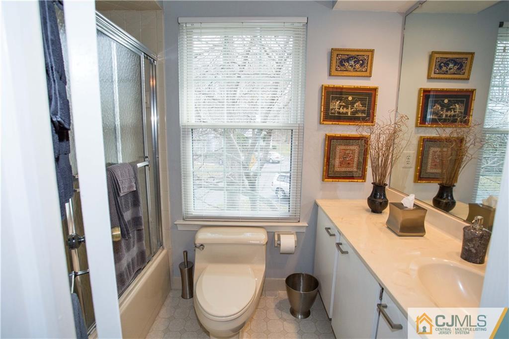 1301 Timber Oaks Road, Unit 1301 Edison, NJ 08820 - Photo 22 of 25 a bathroom with a toilet sink a shower and a window