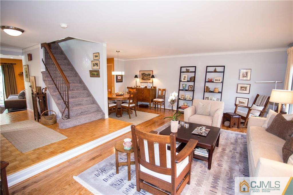 1301 Timber Oaks Road, Unit 1301 Edison, NJ 08820 - Photo 4 of 25 a living room with furniture and wooden floor