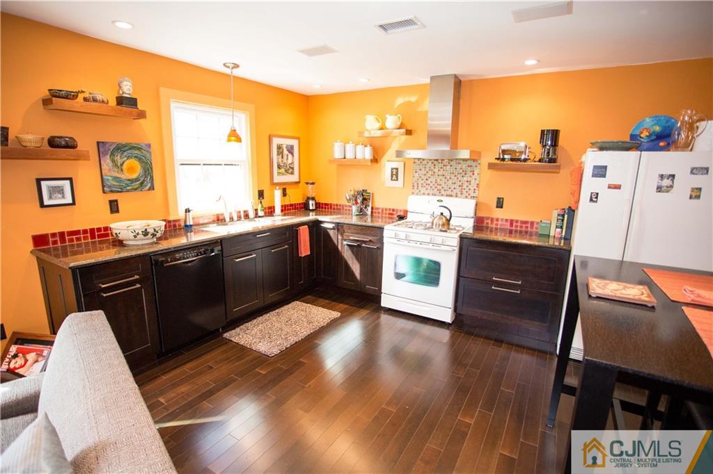 1301 Timber Oaks Road, Unit 1301 Edison, NJ 08820 - Photo 6 of 25 a kitchen with stainless steel appliances granite countertop a stove a sink and a refrigerator