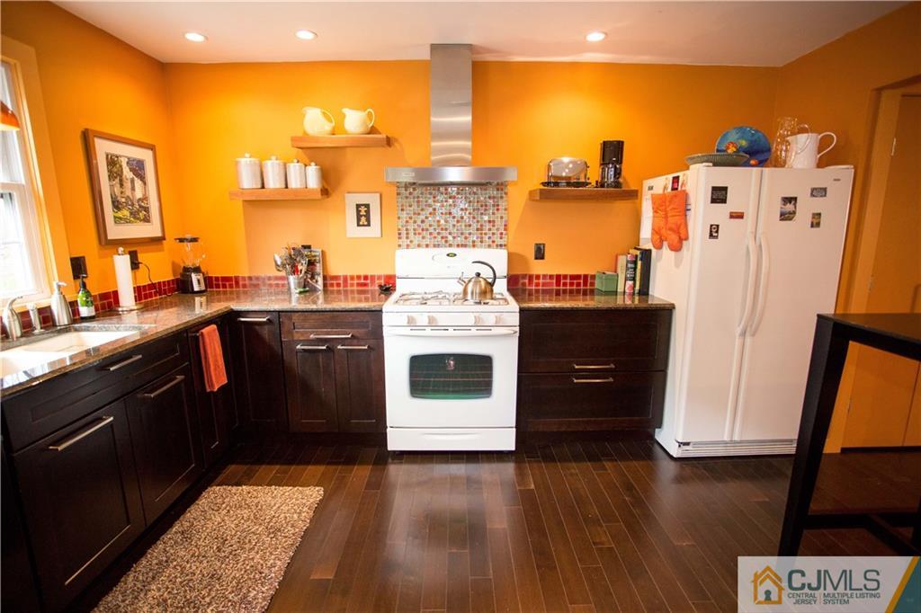 1301 Timber Oaks Road, Unit 1301 Edison, NJ 08820 - Photo 7 of 25 a kitchen with stainless steel appliances granite countertop a stove and a refrigerator