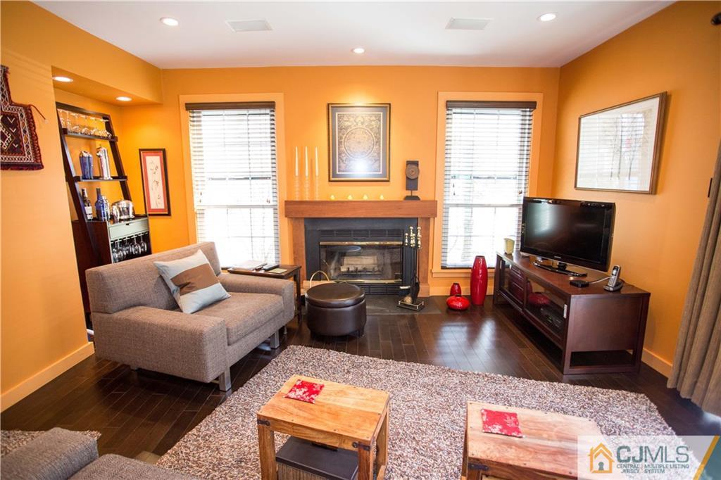 1301 Timber Oaks Road, Unit 1301 Edison, NJ 08820 - Photo 10 of 25 a living room with furniture and a flat screen tv