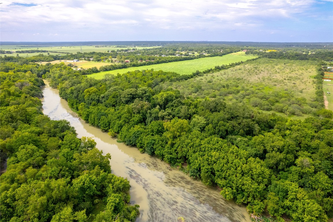 969 Rd Elgin Tx 78602 Road Elgin, TX 78621 - Photo 17 of 17 a view of a yard with a building in the background