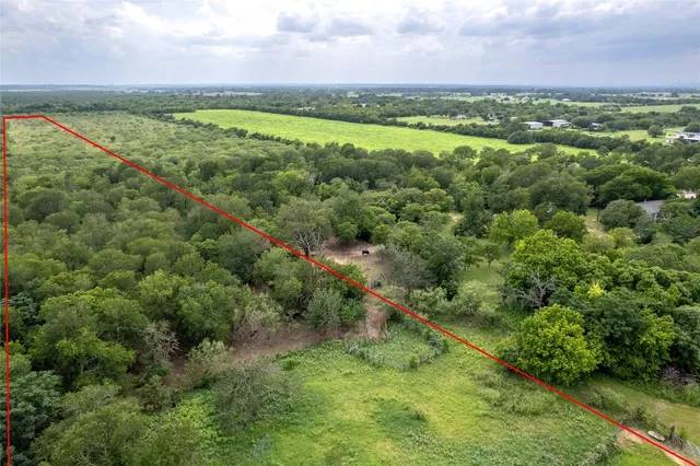 a view of a green field with an ocean