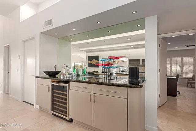 a kitchen with granite countertop a sink and stainless steel appliances