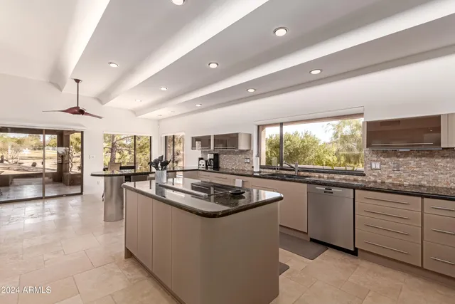 a kitchen with kitchen island granite countertop a sink and counter top space