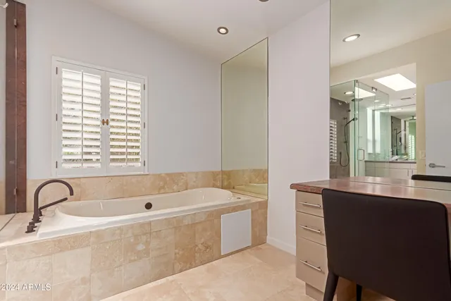 a bedroom with a bed desk and a window