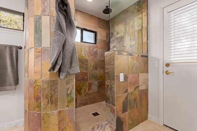 a view of a roof deck with couches and sky view