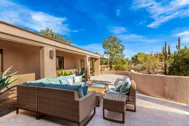 a dining room with furniture and a floor to ceiling window
