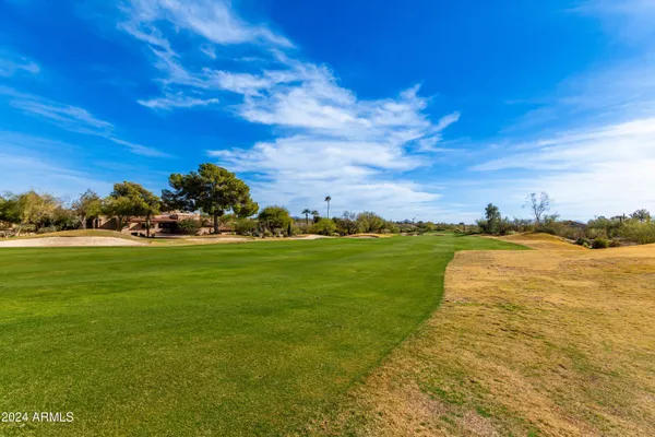 a dining room with furniture and a floor to ceiling window