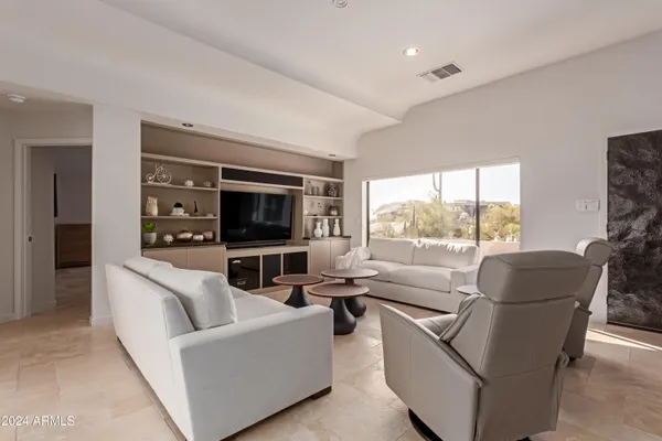 a living room with furniture and a large window